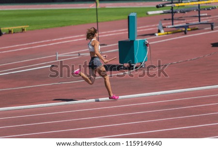 The athlete runs on the racetrack of stadium