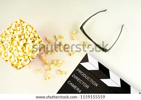 Cinema 3D glasses, popcorn and clapperboard on white background, isolated
