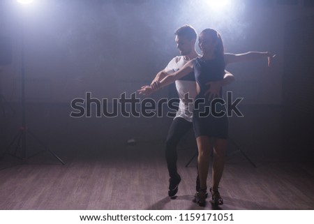 Active happy adults dancing bachata together in dance class Royalty-Free Stock Photo #1159171051