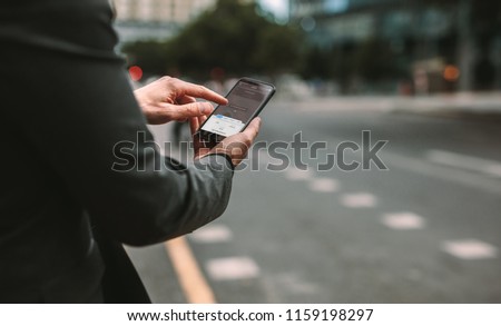Online ride sharing and carpool mobile application. Rideshare taxi app on smartphone screen. Male commuter using online transportation service. Royalty-Free Stock Photo #1159198297