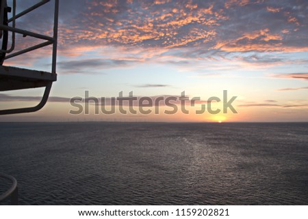 Sunset in the Pacific Ocean. Different types of sunset from the side of the ship while underway and anchoring at the port. Riot of colors of the ocean, clouds and sun.