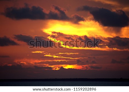 Sunset in the Pacific Ocean. Different types of sunset from the side of the ship while underway and anchoring at the port. Riot of colors of the ocean, clouds and sun.