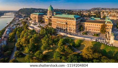 Budapest, Hungary - Aerial panoramic view of the beautiful Buda Castle Royal Palace at sunrise with Gellert Hill and Statue of Liberty at background Royalty-Free Stock Photo #1159204804