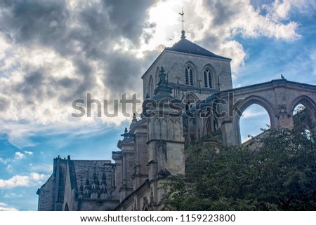 Caen, Calvados, Normandy. Church of Old Saint-Sauveur ( Vieux-Saint-Sauveur or Saint-Sauveur-du-Marche) on the background of an expressive, picturesque cloudy sky.