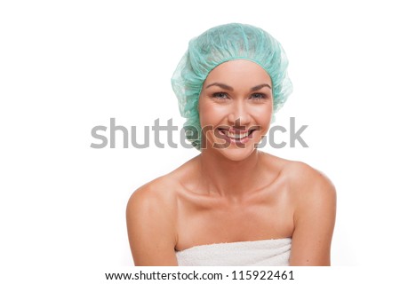 Smiling healthy woman in a shower cap isolated on white in a personal hygiene concept Royalty-Free Stock Photo #115922461