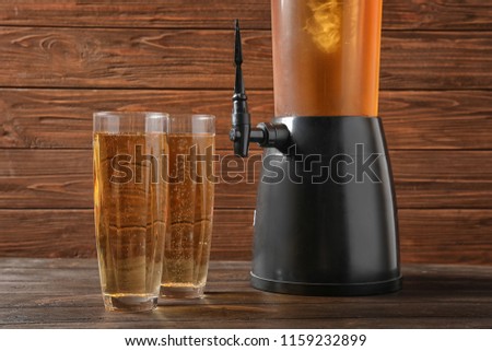 Tower dispenser and glasses with cold beer on table Royalty-Free Stock Photo #1159232899