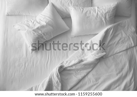 Soft pillows on comfortable bed, top view Royalty-Free Stock Photo #1159255600