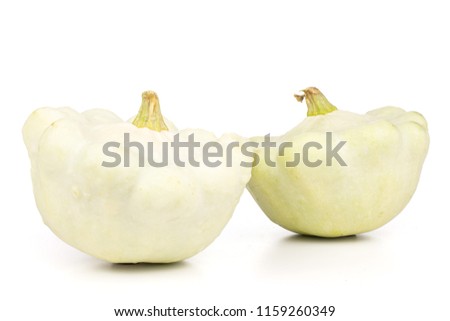 Group of two whole ripe summer white pattypan squash isolated on white background
