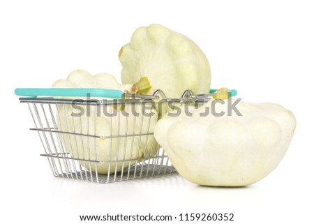 Group of three whole summer white pattypan squash with shopping basket isolated on white background