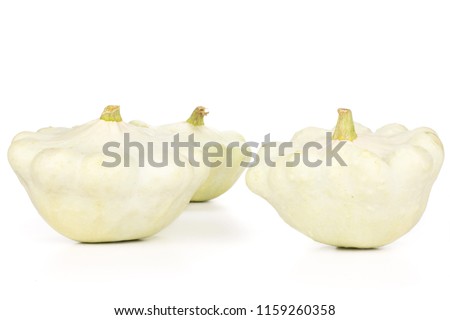 Group of three whole summer white pattypan squash isolated on white background