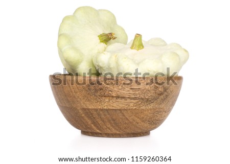 Group of two whole summer white pattypan squash with wooden bowl isolated on white background