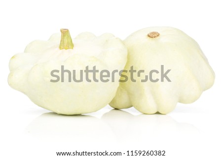 Group of two whole fresh summer white pattypan squash isolated on white background