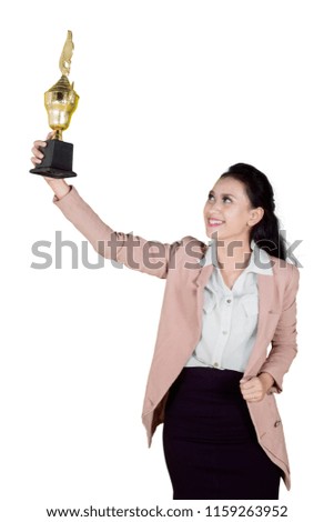 Young beautiful Asian businesswoman winning a trophy isolated over white background