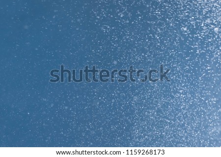 Abstract blue sky blurred background with bokeh and white glitter 