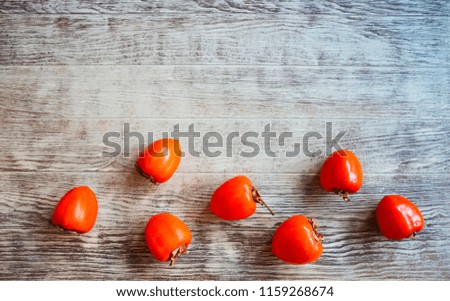 Top view of ripe persimmons on wooden rustic table 