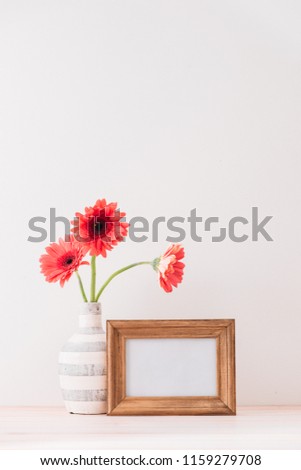 White landscape frame mock up with a vase of gerbera beside the frame, overlay your quote, promotion, headline, or design, great for small businesses, lifestyle bloggers and social media campaigns