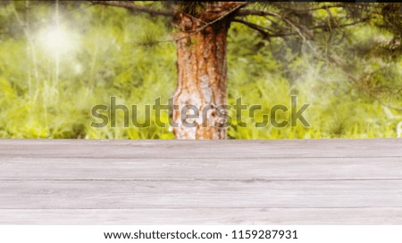 Surface of the wooden table and the blurred yellow-green background. Template mock up for display of product