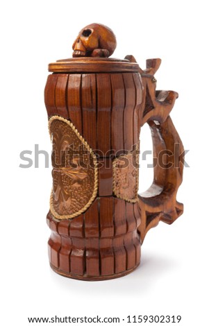 A wooden handmade mug with a skull and a bone on the lid. Isolated on white background. Pirate symbols.