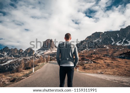 Handsome man amazing mountains background, sport, sport, jumping, resting in a mountains, hiking, travel time, happy, road, nature, sporty guy, alps, dolomites, attractive, belt, sneakers, jeans