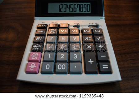 Calculator for calculations on brown table

