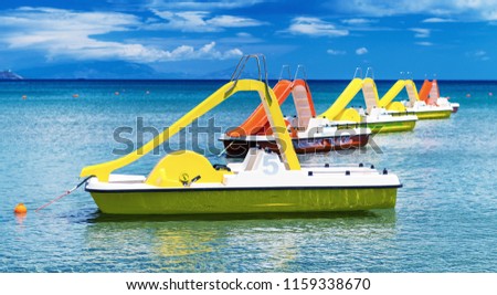 Colourful pedalos in the water on a beautiful summer day. Royalty-Free Stock Photo #1159338670
