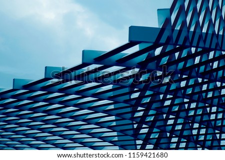 Close-up photo of metal grid structure. Abstract metallic framework background on the subject of modern architecture, building exterior, construction industry or technology.