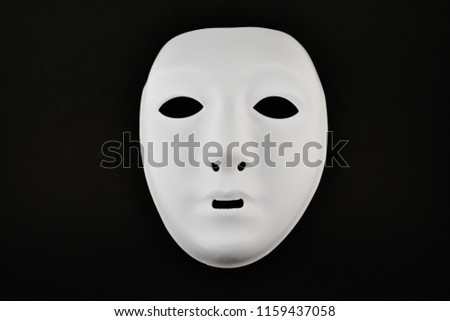 Plastic white face mask stock images. White mask on a black background. Plastic human mask