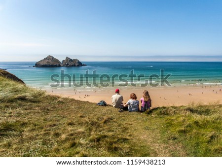 Newquay Holywell Bay beach, family seating and enjoys views of the island on the water Royalty-Free Stock Photo #1159438213