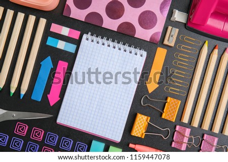 Flat lay composition with different school stationery on chalkboard surface