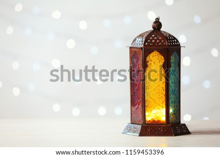 Muslim lamp Fanus and space for design on blurred lights background Royalty-Free Stock Photo #1159453396