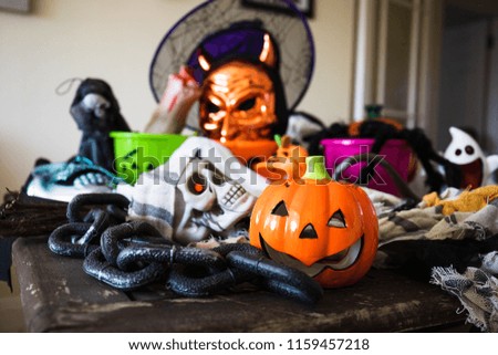 An old wooden table covered in all sorts of Halloween decorations