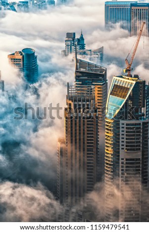 Fog covering buildings and skyscrapers in the early morning in Dubai. 