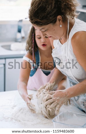 Mother and daughter making bread at home