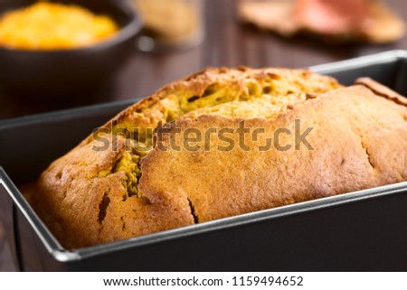 Fresh homemade pumpkin bread in pan (Selective Focus, Focus one third into the bread) Royalty-Free Stock Photo #1159494652