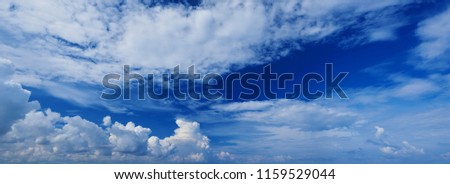 Wide panoramic view of romantic navy blue sky with white grey clouds. High resolution artistic skyline background image. Sky panorama