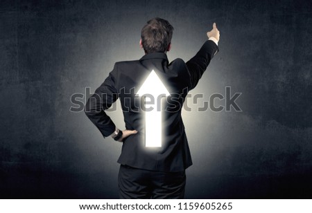 Young businessman standing and thinking about which direction to choose