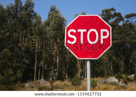 Red stop traffic sign and natural background