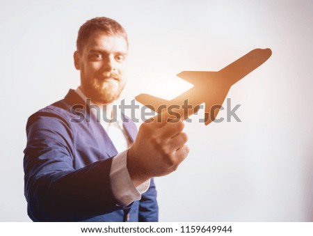 Man proposing signing a life insurance policy, the agent is holding the wooden plane model. Life insurance concept.