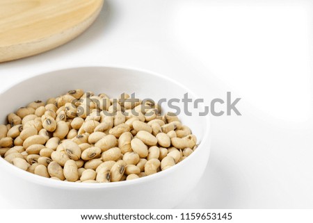 Roasted Soy in White Ceramic Bowl and Round Wood Dish isolated on White Background.