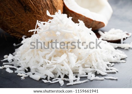 Fresh coconut flakes on a black background Royalty-Free Stock Photo #1159661941
