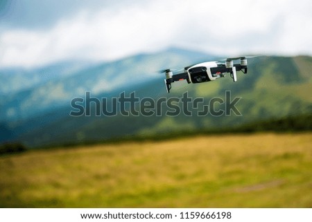 The drone with the professional camera takes pictures in the mountains