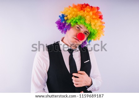 Office worker in clown wig, clown concept at work. Businessman with clown wig isolated on white

