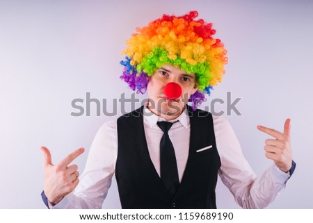 Office worker in clown wig, clown concept at work. Businessman with clown wig isolated on white

