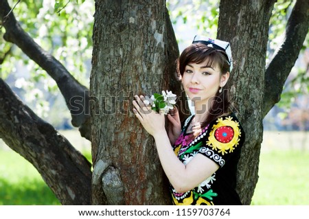 Girl, woman in national historic Tajik costume. Central Asia