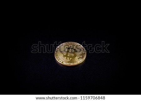 Gold coin bitcoin isolated on black background with reflection.