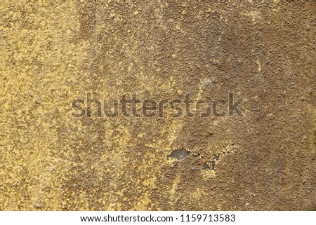 Yellow and brown old plaster of facade house