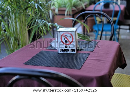 No smoking tissue box on restaurant table.					