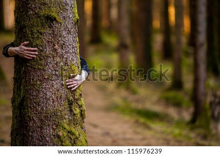 hugging a tree Royalty-Free Stock Photo #115976239