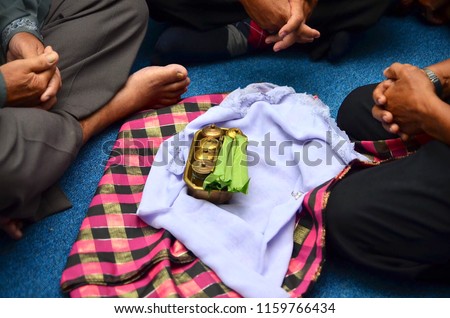 Group of men discuss for wedding after sending golden tepak sirih. Tepak sirih is one of the cultural heritage of Malay's objects used as a medium during Malay community ceremony. Royalty-Free Stock Photo #1159766434