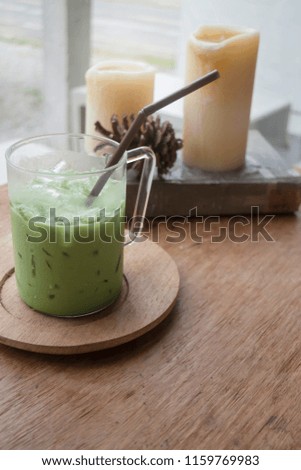 Iced green tea latte on wooden table, stock photo